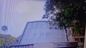 A building with a patterned facade and a sign for 'Sapporo Guest House.' - sapphire guest house (Kolkata)