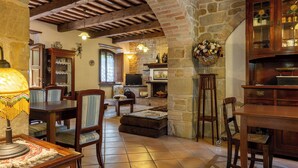 A rustic interior with exposed wooden beams, stone walls, a fireplace, and traditional furnishings. - Vacation Home in Perugia with 3 bedrooms sleeps 7 (Perugia)