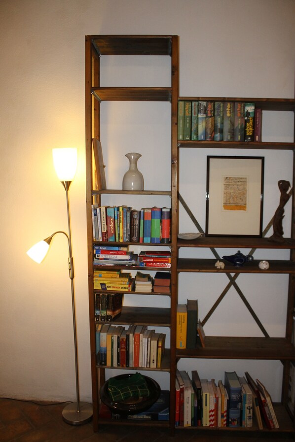 A bookshelf with books and a framed picture.