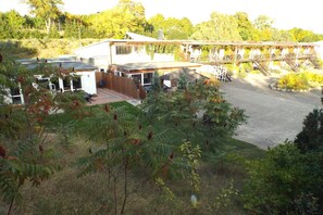 A residential property with a covered patio, a fenced yard, and a staircase leading to a second level.