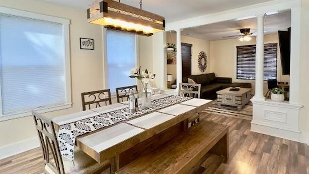 A dining area with a long table, chairs, and a hanging light fixture. - Cozy Craftsman Home by 6th Ave. Entire home in Tacoma, Washington (Tacoma)