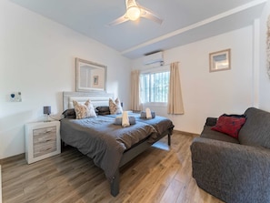 A bedroom with a bed, bedside table, and a window with curtains. - Modern Beachfront Escape, Calahonda (Mijas)