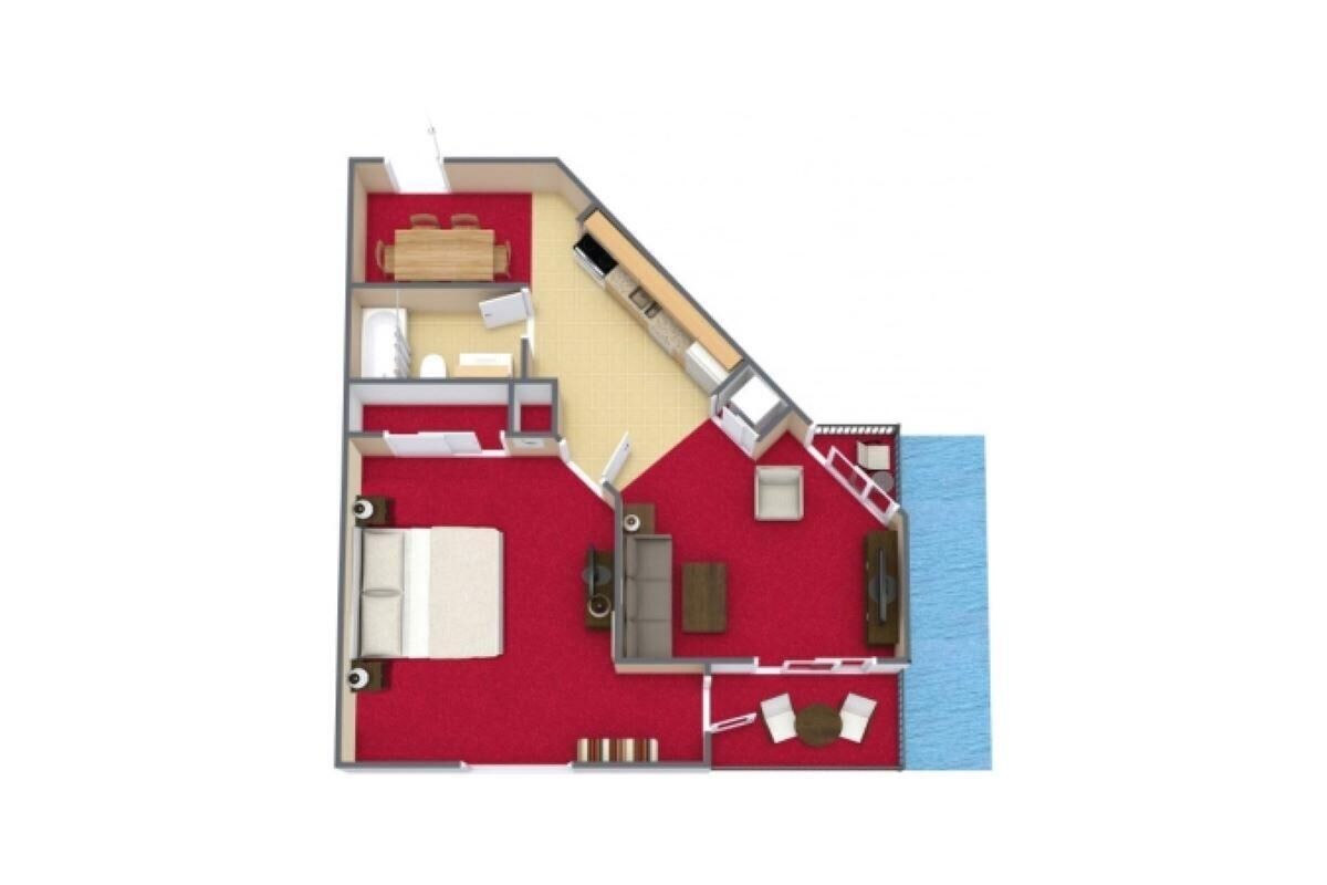 A hotel room layout with a bed, seating area, kitchenette, and a small bathroom.