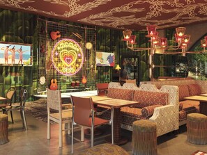 A cozy interior with a neon heart sign, a guitar, and a cartoon character on the wall. - Mama Shelter Lake Como (Como)