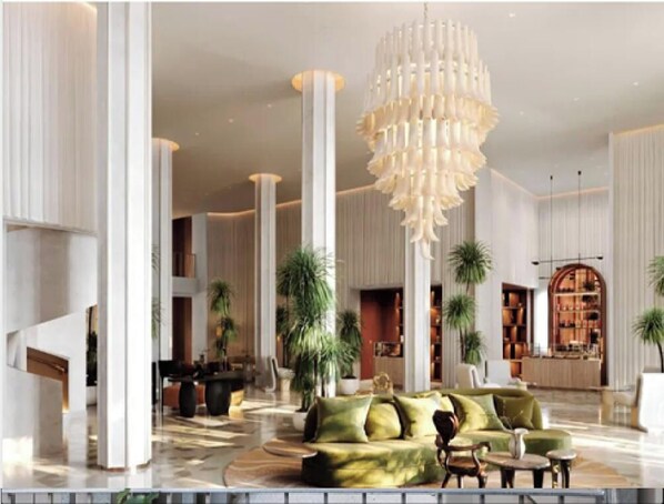 A spacious lobby with high ceilings, a large chandelier, and a seating area with a green sofa. - Mama Shelter Lake Como (Como)