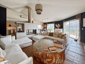 A modern living room with a glass coffee table, a sofa, and a piano. - Large charming villa Porto-Vecchio swimming pool/poolhouse in private grounds (Porto-Vecchio)