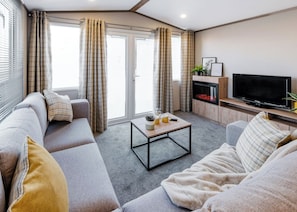 Living area - Modern, spacious holiday caravan with two bedrooms sleeping four people. (Golspie)
