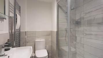 Shower, hair dryer, towels, shampoo