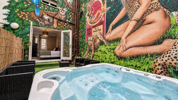 A hot tub with a mural of a leopard and a person in leopard print clothing. - The Brighton Parlour with Hot Tub (Brighton)