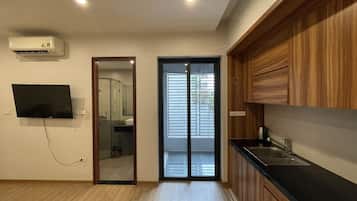 Una cocina moderna con armarios de madera, encimera negra y lavaplatos empotrado.