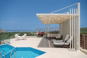 A rooftop pool area with a view of the sea, outdoor seating, and a covered patio. - Seaview Luxury Villa In Chania (Kissamos)