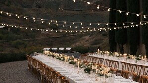 An outdoor dining area with string lights, white tablecloths, and wooden chairs. - Little Daisy Manson |Two Villas | Sleeps 33 Jerome (Sedona)