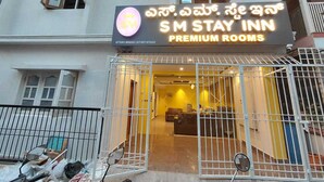 A hotel entrance with a sign for 'SM STAY INN PREMIUM ROOMS'. - SM Stay Inn (Bengaluru)