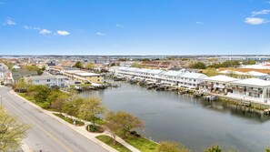 A marina with boats docked, surrounded by residential buildings and a clear sky. - Renovated 3BR condo. Short walk to beach. Community Pool. FREE Linens (Ocean City)