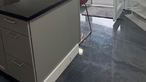 A modern kitchen with a black countertop, stainless steel appliances, and a view of the outside through a glass door. - 3BR Retreat • Private Patio • Near DC & Pentagon (Springfield)