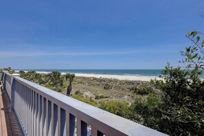 Un balcón con vista a la playa y el océano.