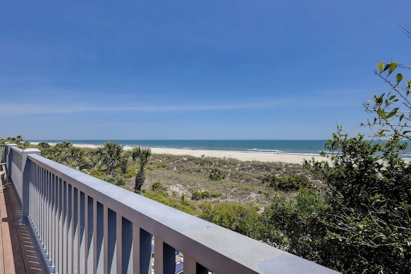 A balcony with a view of a beach and ocean. - 15 Dune Lane - Oceanfront Views Await - Summer Discounts Available! (Hilton Head Island)