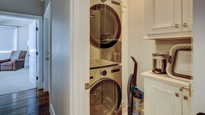 A laundry room with a washing machine, dryer, and stacked cabinets. - 15 Dune Lane: Oceanfront Views Await, New Pool & Additions Coming Spring '27! (Hilton Head Island)