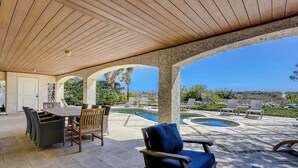 A covered patio with a pool, outdoor furniture, and a view of the landscape. - 15 Dune Lane: Oceanfront Views Await, New Pool & Additions Coming Spring '27! (Hilton Head Island)