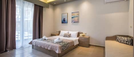 A bedroom with a bed, bedside tables, an air conditioning unit, and a window with curtains.