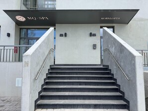 Entrada de un edificio con un cartel de MQ SPA y Kornlofts.