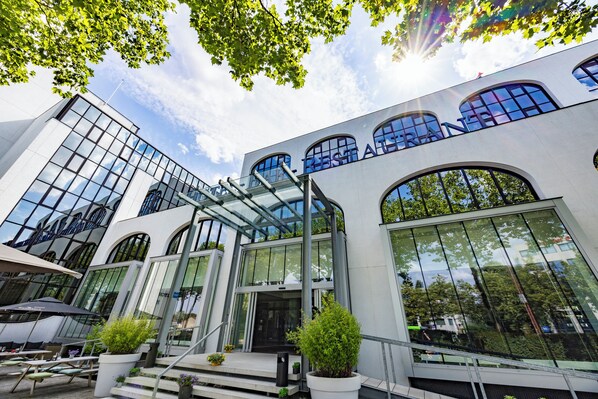A modern building with large windows and a glass entrance.