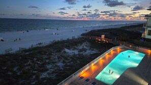 A beach view with a swimming pool and beachgoers. - Summerchase 305 by Liquid Life (Orange Beach)