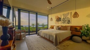 Una camera da letto con un letto, una ventola a soffitto, un'ampia finestra e vista su piante.