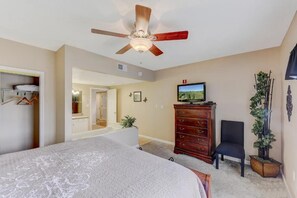 A bedroom with a bed, a dresser, a television, and a ceiling fan. - Two bedroom, two bath condo| Near the Old Mill District| Dollywood| Sleeps 6 (Pigeon Forge)