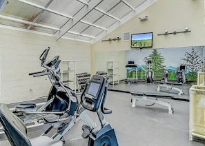 A gym with exercise equipment, a television, and a mural on the wall. - Two Bedroom, Two bathroom Condo in Pigeon Forge| Near Dollywood| Sleeps 6 (Pigeon Forge)