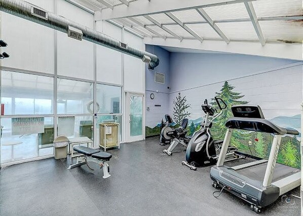 A gym with exercise equipment, a bench, and a large window. - Two Bedroom, Two bathroom Condo in Pigeon Forge| Near Dollywood| Sleeps 6 (Pigeon Forge)