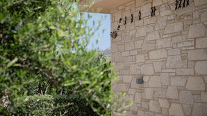 A stone wall with carved figures and a basket hanging on it. - Stunning Mediterranean Villa for 6 (Kissamos)
