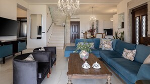 A modern living room with a large sectional sofa, a coffee table, and a TV. - Stunning Mediterranean Villa for 6 (Kissamos)