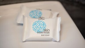 Two bar soap packages labeled 'skin essentials' on a white surface. - Thines Studios : Studio B (Kampos)
