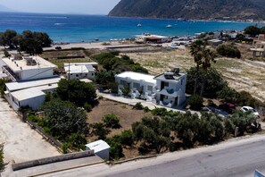 A coastal area with modern buildings, a marina, and boats. - Thines Studios : Studio A (Kampos)