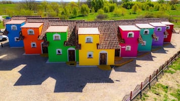 Una hilera de edificios de una sola planta y tejados de tejas, alineados.