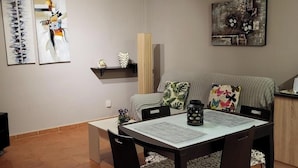 A dining area with a table, chairs, and a ceiling fan. - Apartment With Large Terrace in Almeria (Vera)