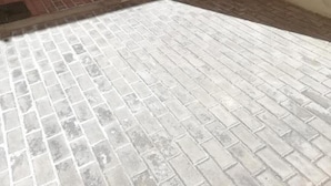 A paved outdoor area with a stone wall and a door. - Charming Apartment With Garden in Almeria (Vera)