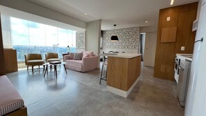 A modern apartment with a living area, kitchen, and large windows offering a city view. - Best View in SP - 62 m2 Apartment - 10 min from Butantã Metro Station (Yellow Line) (São Paulo)