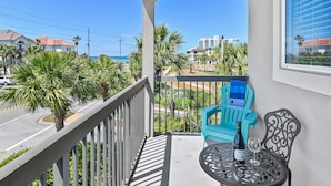 A balcony with a view of the ocean, a chair, a table, and a bottle of wine. - ☀️Private Beach Access | Pool+Hot Tub | Walk to Beach | Alerio D301⛱️ (Miramar Beach)