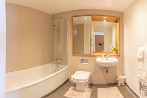 A modern bathroom with a glass-enclosed shower, a standalone toilet, and a sink with a mirror above. - Greenwich Apartment Near Cutty Sark and Paid Parking (London)
