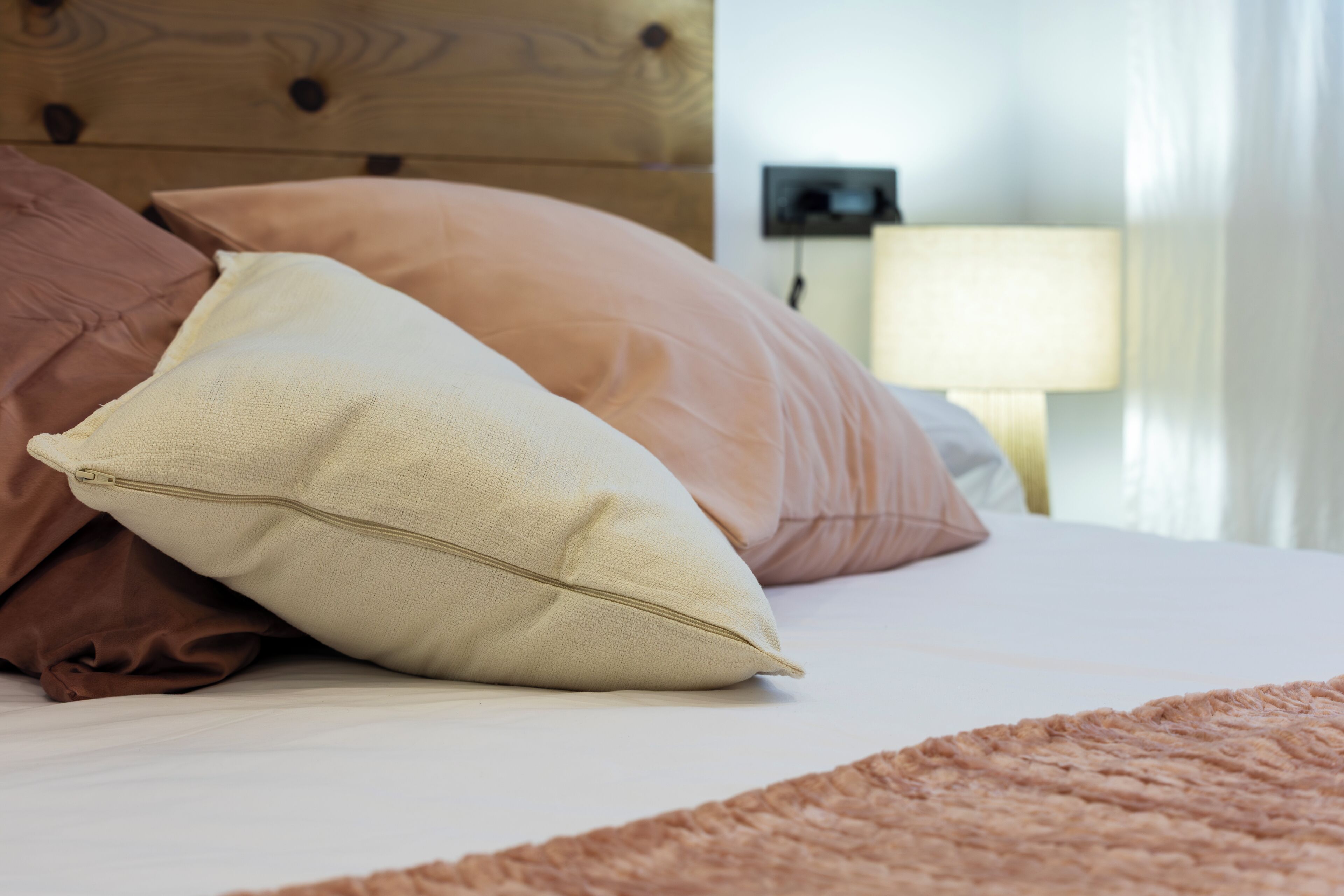 A bed with pillows and a blanket.