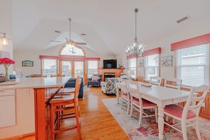 A spacious kitchen with a dining area, a ceiling fan, and a large window. - JL #824 - Semi-Oceanfront - Private Swimming Pool (Nags Head)
