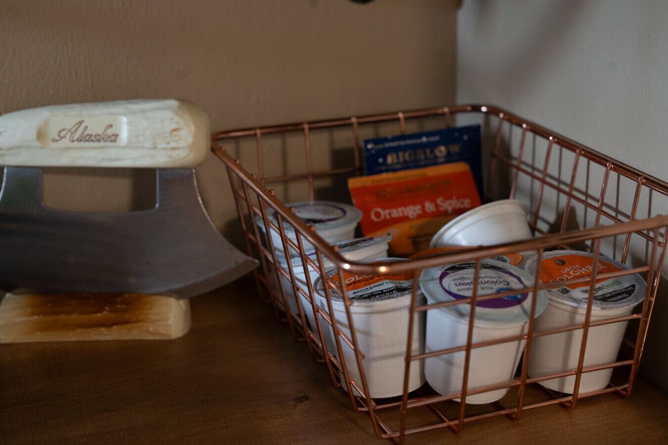 A metal basket containing yogurt containers and a box labeled 'Orange & Spice.'
