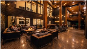 A spacious lobby with a fire feature, comfortable seating, and a staircase. - Sleeps 38, Luxury Lodge, Gym, Golf, Theater & HotTub, children area, workstation (Broken Bow)