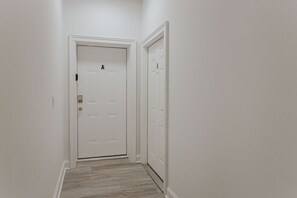 A narrow hallway with a white door labeled 'A' and a white door labeled 'B'.