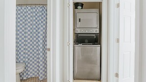 A compact kitchen with a microwave, oven, and a small countertop area.