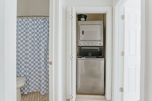 A compact kitchen with a microwave, oven, and a small countertop area.