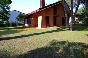 A single-story building with a flat roof, a covered porch, and a well-maintained lawn.