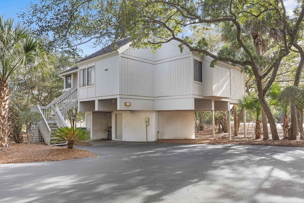 A two-story house with a covered porch, a staircase, and a garage door.